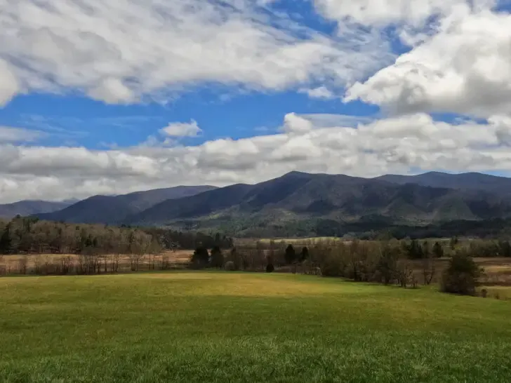 beautiful smoky mountains white puffy clouds and green meadow in Cades Cove Smoky Mountains August vacations
