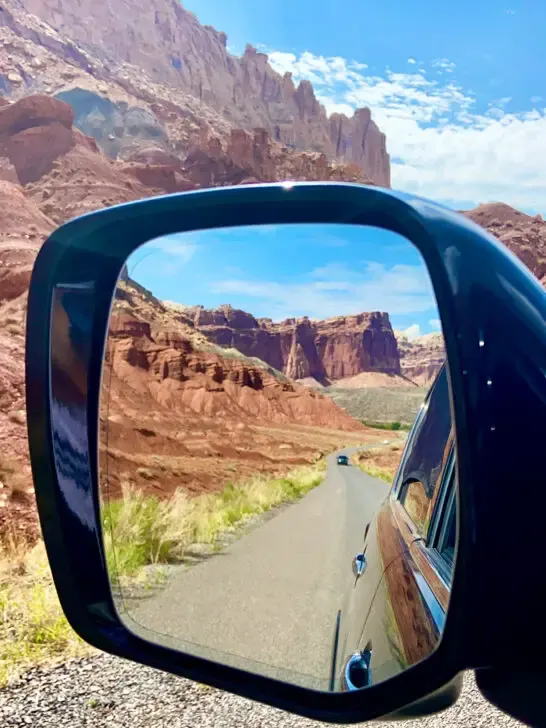 best national parks kids view of rear view mirror with red rock canyon