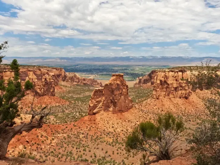 colorado national monumento view of large rock valley with mountains in distance