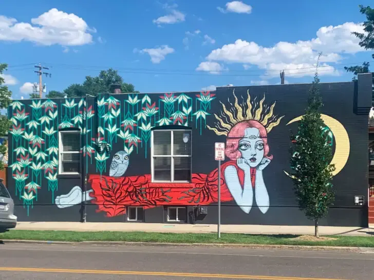 street art on building with woman flowers and moon