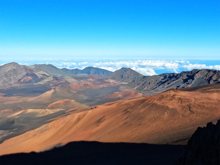 best national parks for kids view of colorful dirt crater above clouds with blue sky