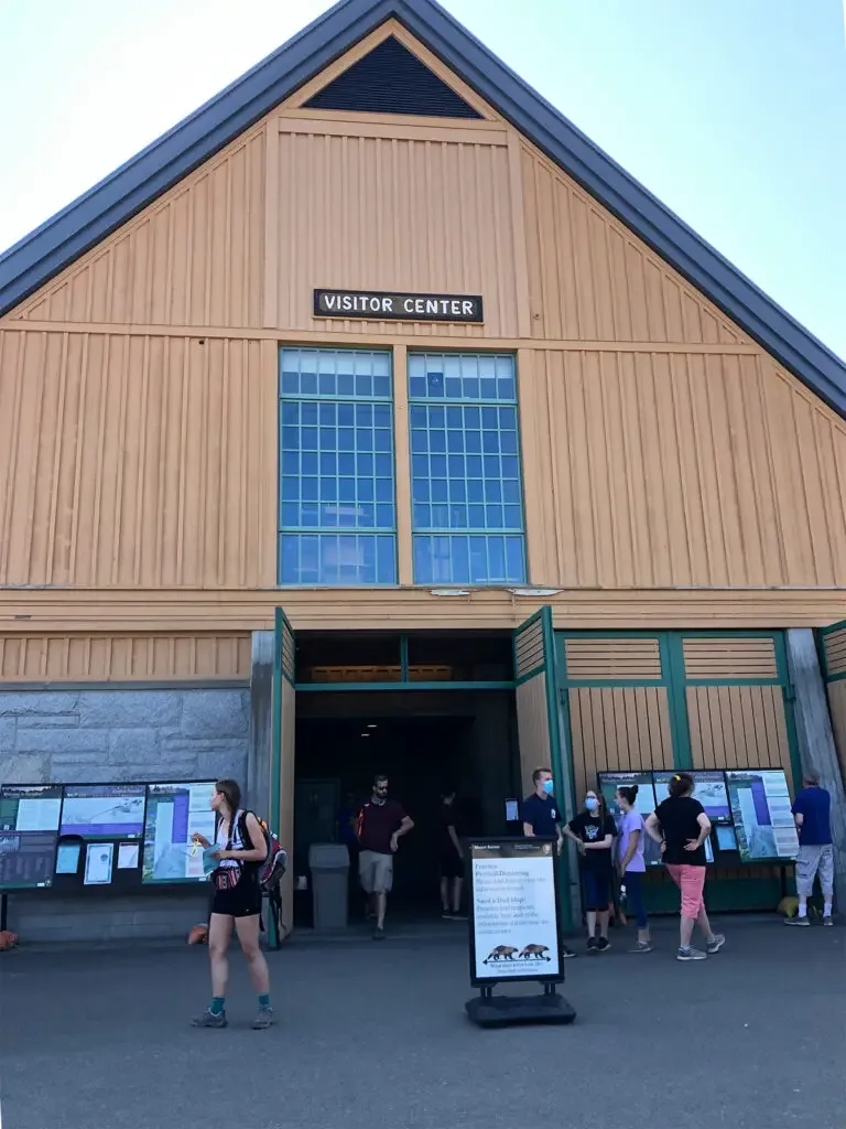 large building that says visitor center and people in front of it