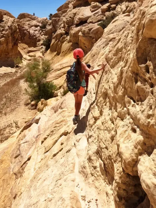 kids climbing rocks yellow rock on sunny day on calico tanks trail