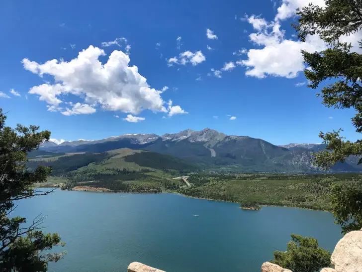 view of blue lake with mountains and trees at sapphire point overlook