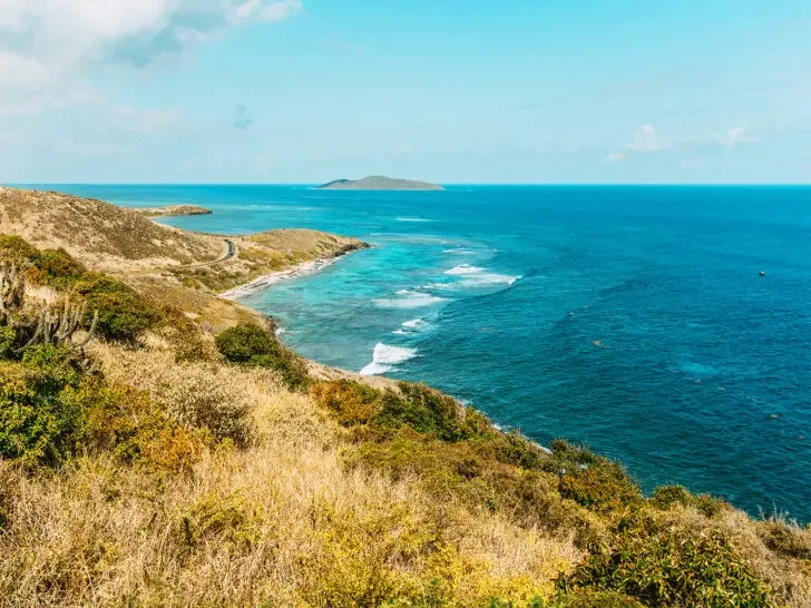 best place to travel in august view of ocean cliffs and blue water in US Virgin Islands