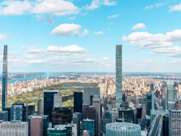 best places to visit in August view of Central Park with high rise buildings surrounding it on a sunny day