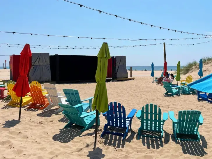 best places to travel in August USA view of chairs and stage with lights on beach in Michigan