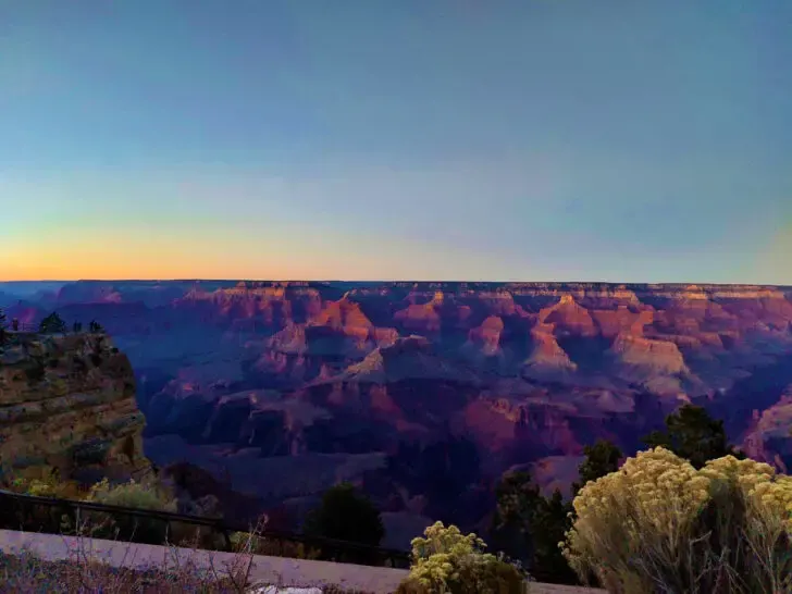fall road trips view of Grand Canyon at sunset with pink and purple canyon dark sky