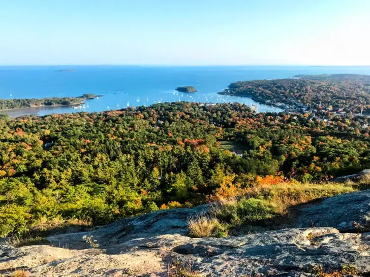 fall drives view of coast from hillside with fall foliage