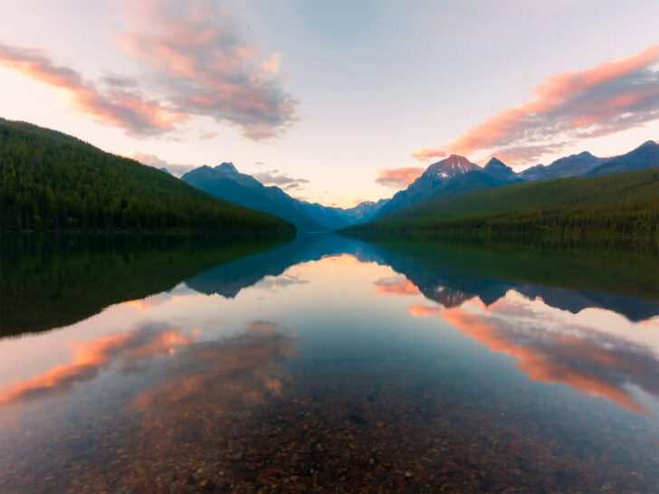 sunset at glacier national park Montana view of lake with colorful sky, mountains and reflection during best rv trips
