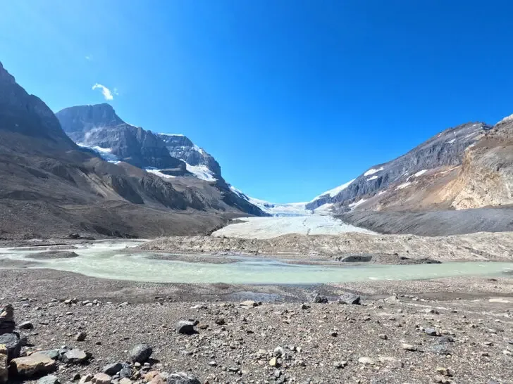 things to do in Banff in summer view of glacier with river and rocks between two mountain peaks