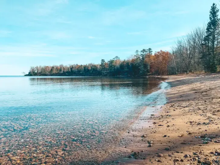 lake on a sunny day with dormant trees best places to visit in November USA