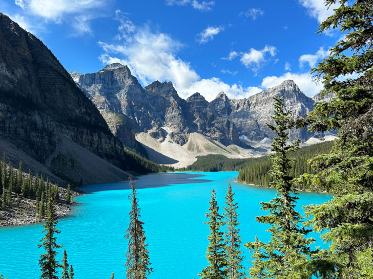 Moraine Lake Banff summer view of bright teal water trees and mountains