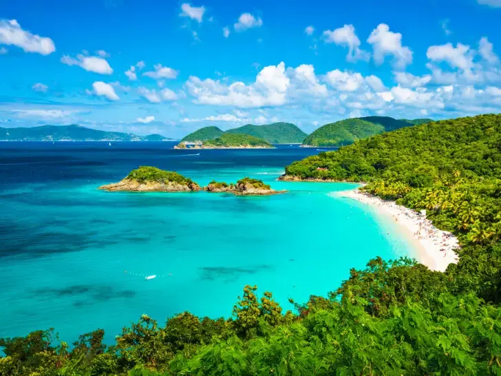 view of teal beach with lush coastline best places to visit in November USA