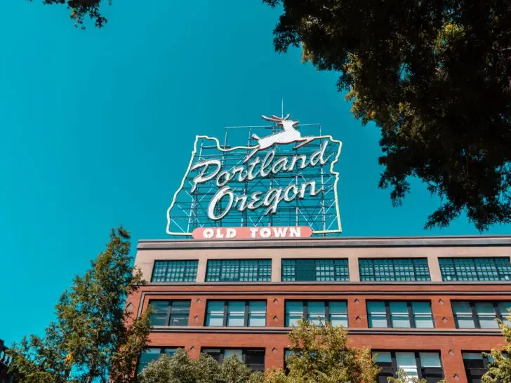 sign on top of building that reads Portland Oregon old town