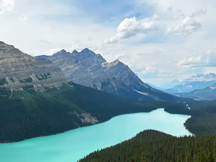 Canadian rockies itinerary view of lake with water shaped like wolf head and mountains in distance