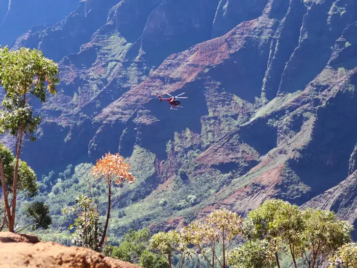 view of large canyon with helicopter flying in it