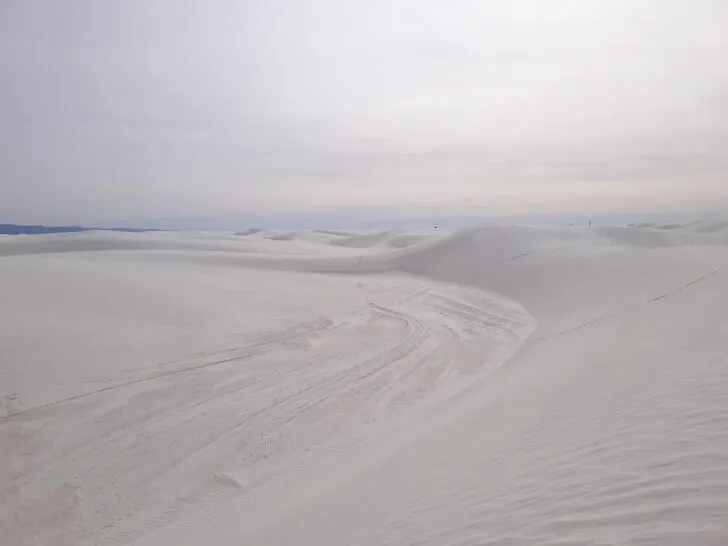 warm winter vacations in the US view of white sands as far as the eye can see with white sky near sunset
