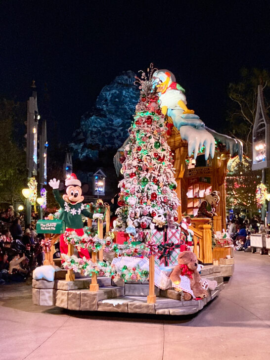parade float decorated with Mikey Mouse and Christmas tree