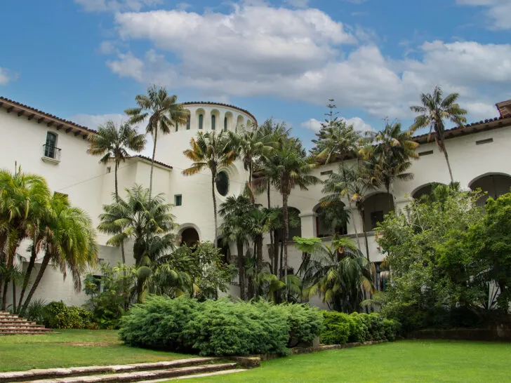 warm winter vacations in the US view of large building with palm trees in Southern California