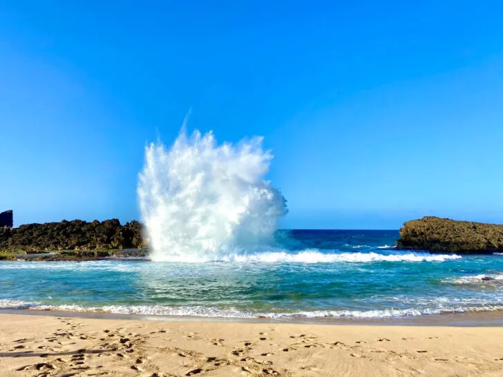 Puerto Rico beach with large wave hitting rock warm vacation spots in US