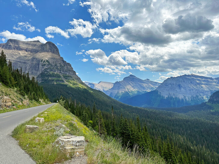 mountain road with stunning scenery in distance must see in glacier national park