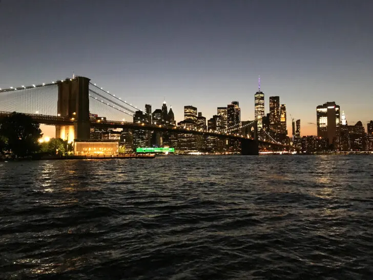 winter road trips with view of NYC skyline and bridge with water in foreground