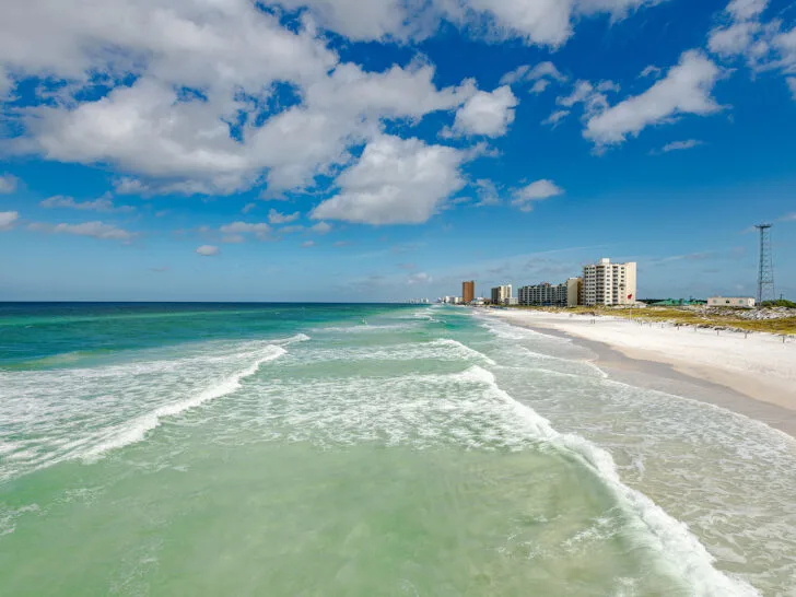 road trips in winter view of Panama City 30a with teal water white waves and city in distance