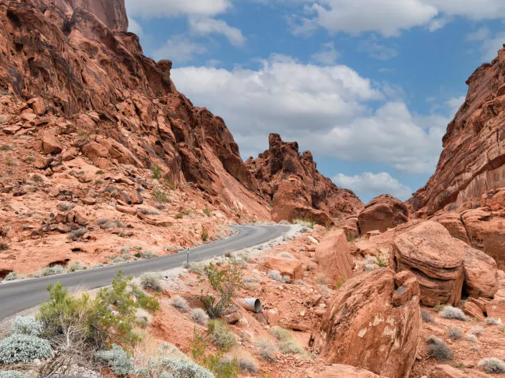 winter road trips in the USA view of road through red rocky cliffs