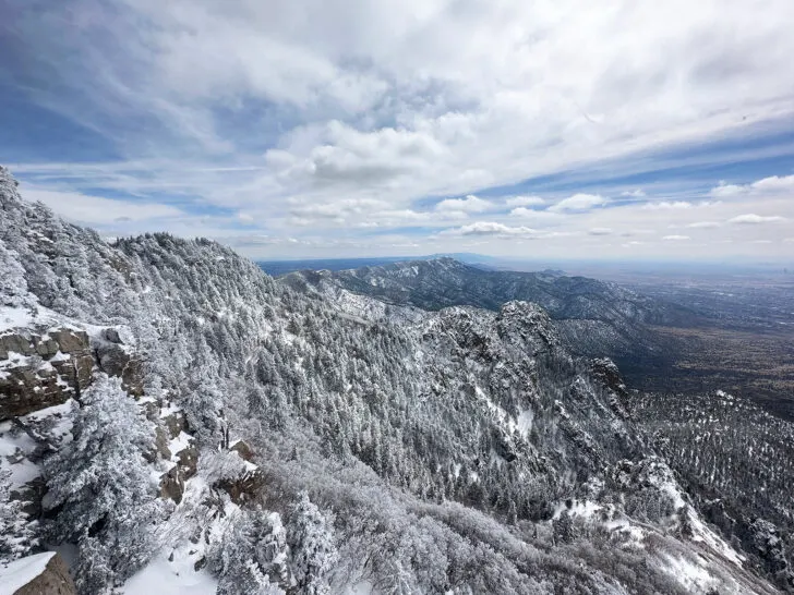 best us winter road trips view of white mountain and snow covered trees with view into the distance