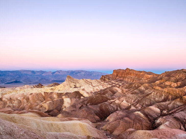 Death Valley in sunset with pink sky and brown mountains