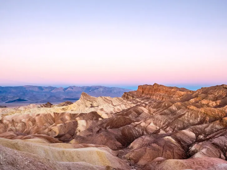 Death Valley in sunset with pink sky and brown mountains
