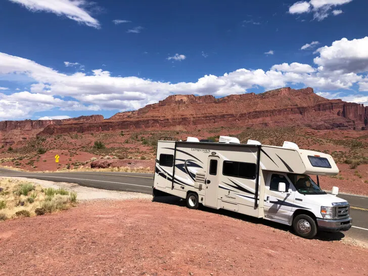 RV camping checklist with view of motorhome on red rock in front of mountains