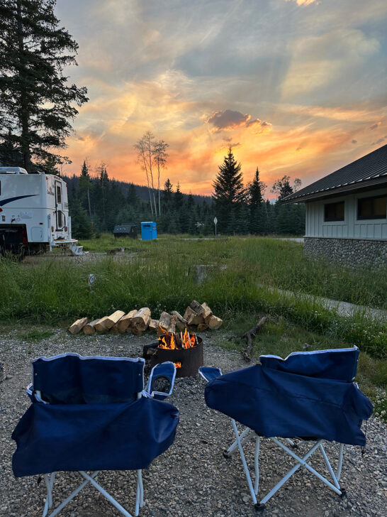 view of camping chairs and fire at sunset camping RV checklist