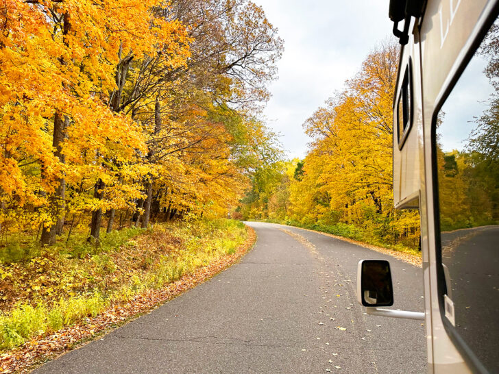 driving down scenic road with yellow trees camping RV checklist