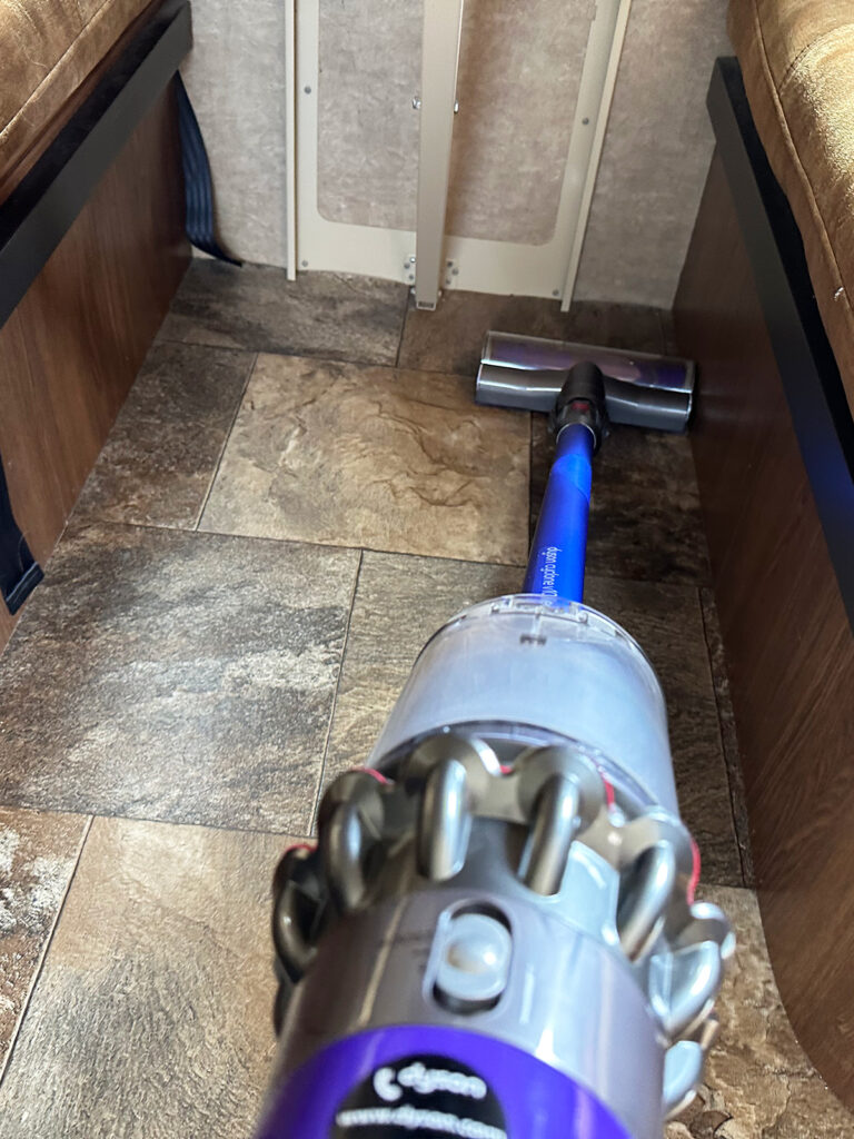 hand held vacuum cleaning bottom of RV floor
