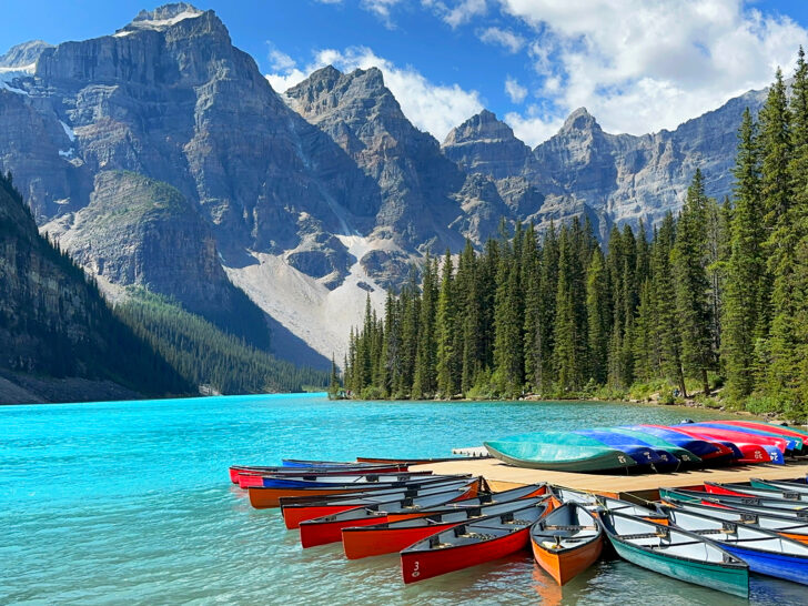 vibrant colored canoes at scenic mountain lake