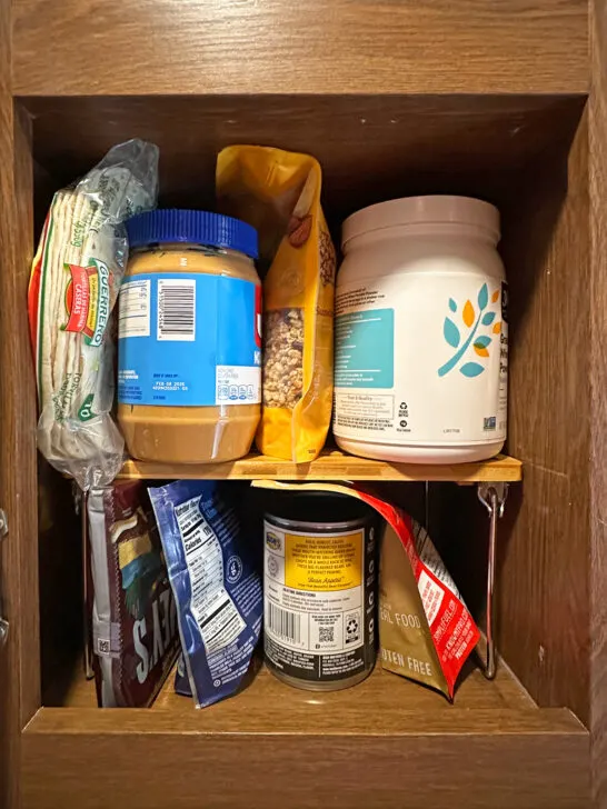 shelf in cabinet with food above and below for organization in campers