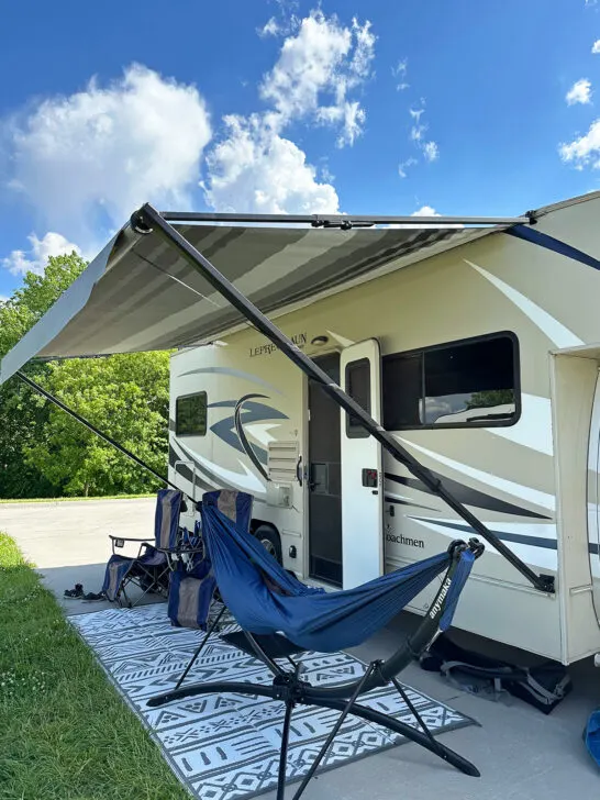 exterior of camper with hammock and chairs