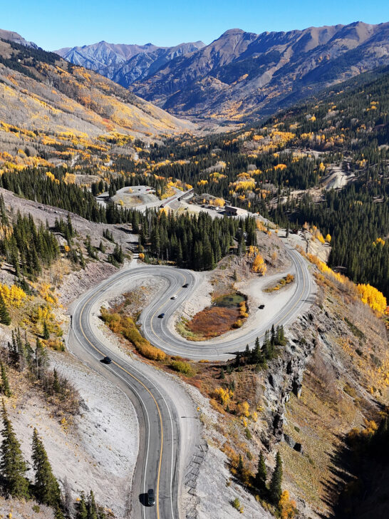 curvy road in mountainside with green and trees on the million dollar highway colorado